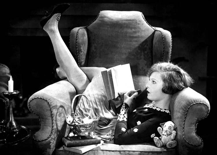 Woman in big chair reading book blank greetings card