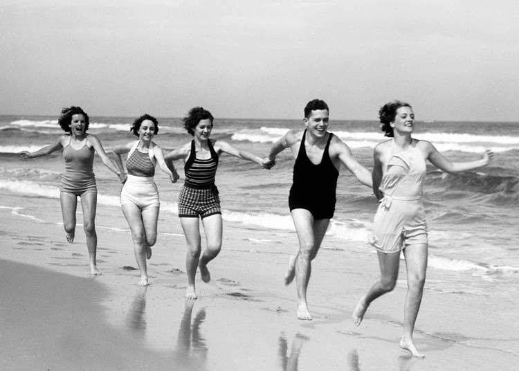 Holding hands on the beach blank greetings card